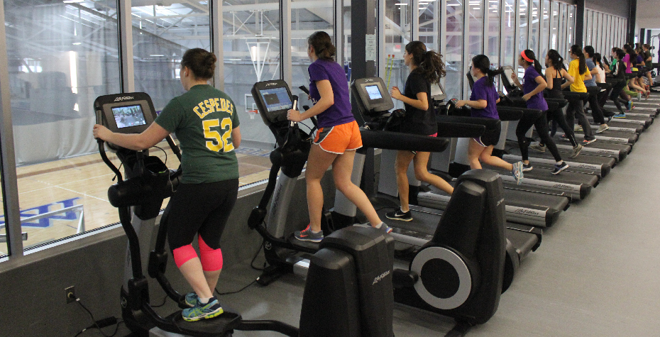 Dorothy Towne Fieldhouse Reopens with Community Celebration students exercising in the new fitness center