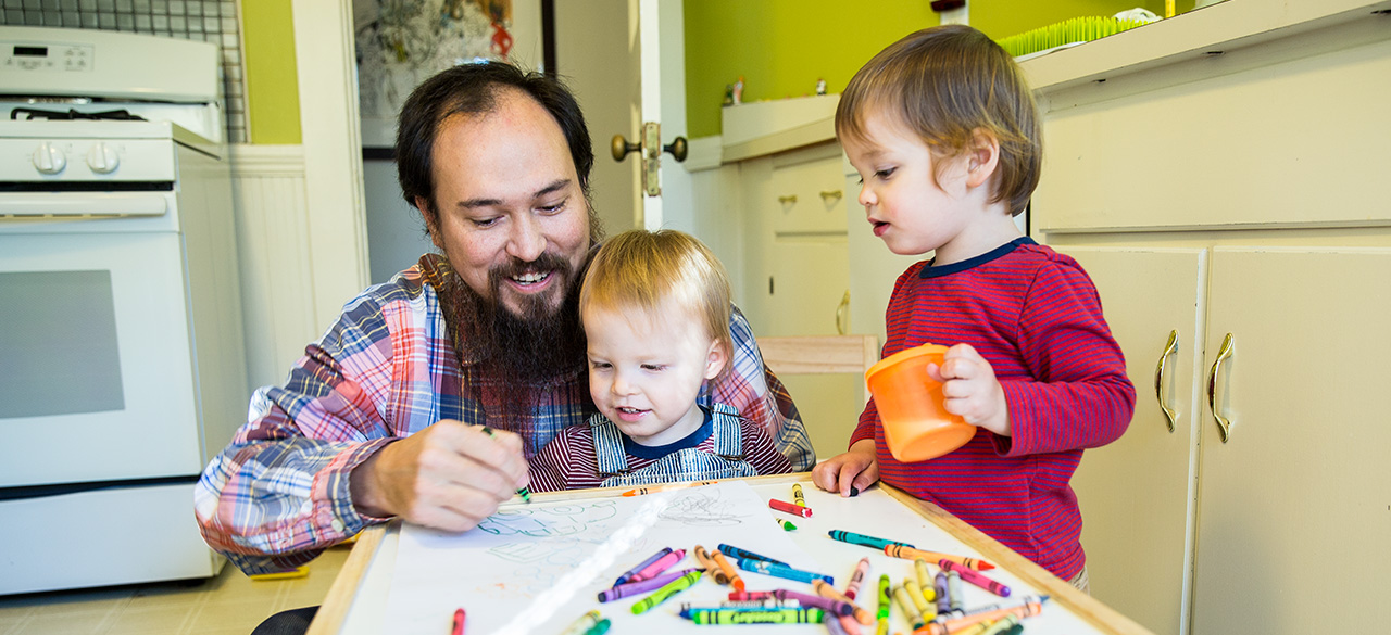 Faculty Members Find Inspiration In Family David Teng-Olsen, assistant professor of art, colors with his sons, Jack and Felix.