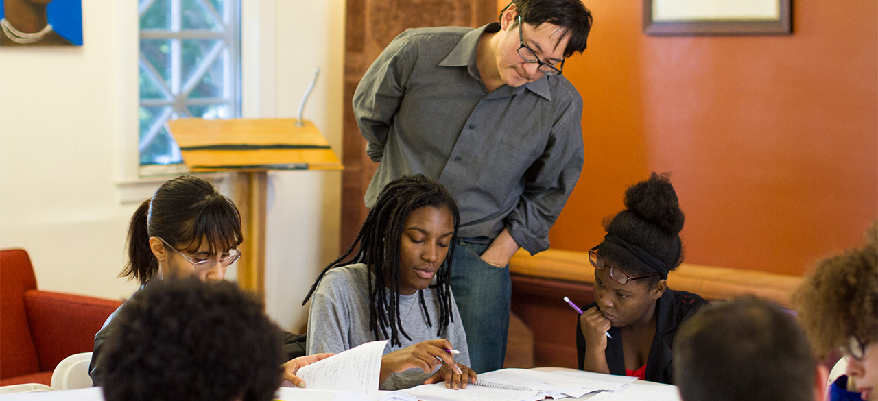 Wellesley Math Program Named a Bright Spot in Hispanic Education Professor Stanley Chang looks on as a group of students study together.