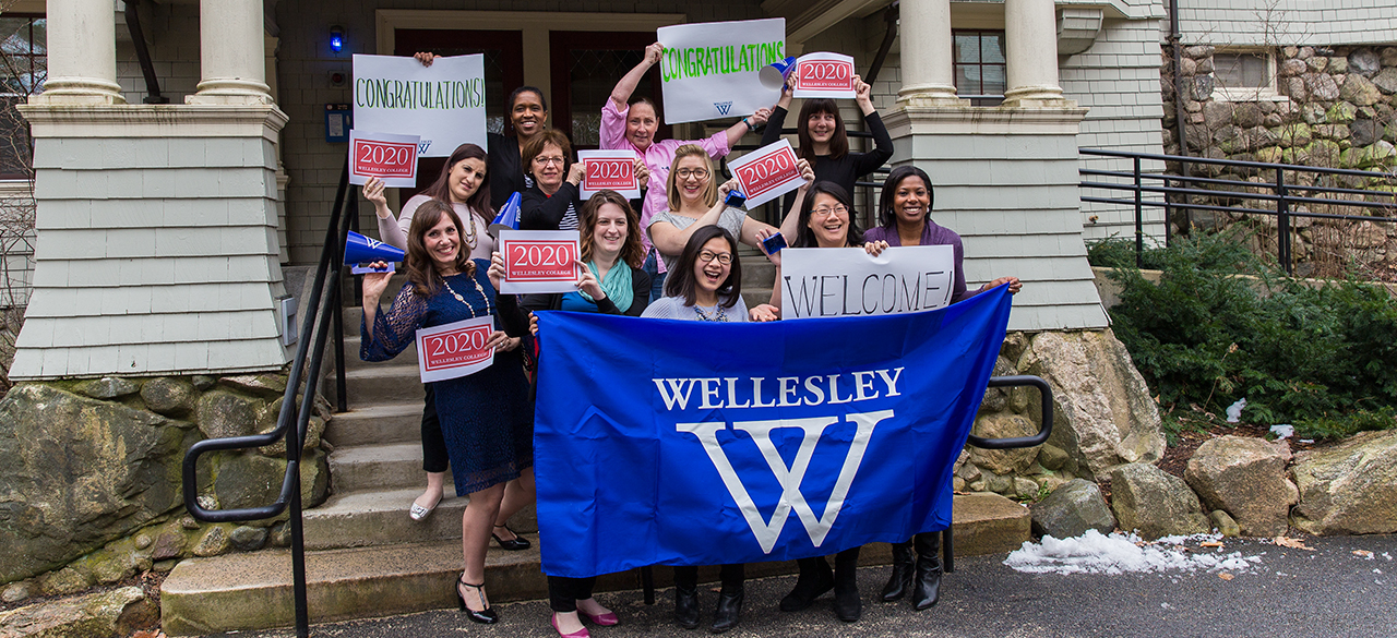Congratulations, Admitted Students! The Admission Office team holds signs welcoming newly-admitted students.