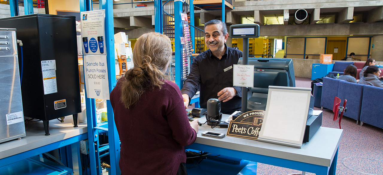 Ashraf Youssef serves a customer at the Leaky Beaker Cafe