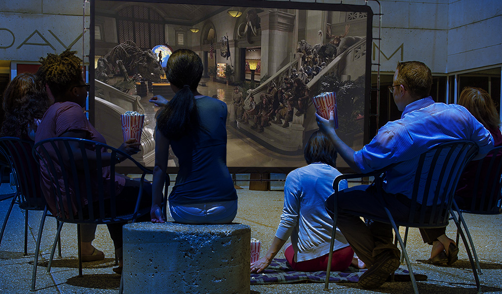 Davis Museum Launches Summer Film Series Crowd watches a film in the Davis Museum plaza.