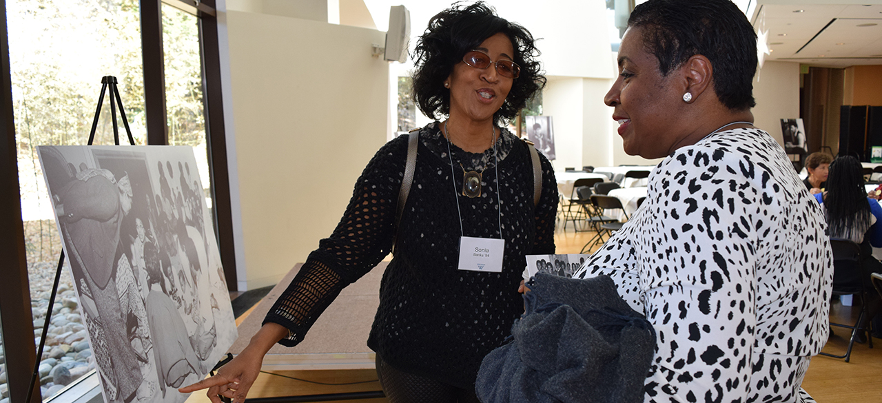 Alumnae view a photo at the Harambee House 45th Anniversary celebration