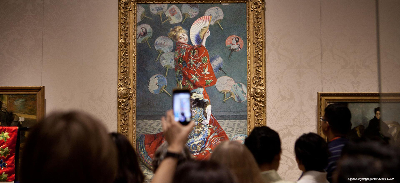 Racial Stereotypes and "Racist Love" Art patron holds up a cell phone during protest MFA protest in front of Claude Monet painting