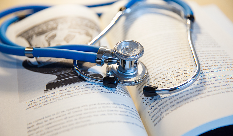 Praise For The Power of The Liberal Arts In Science A stethoscope rests on an open book.