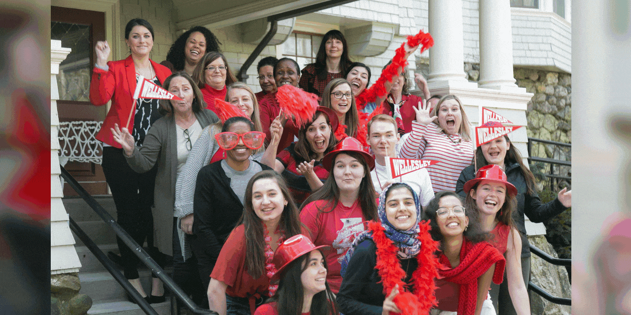 cheering members of the admission office dressed in red
