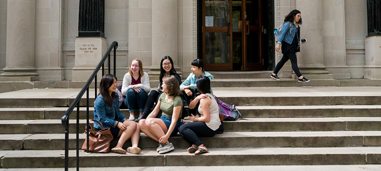 Wellesley students engage in lively discourse on the library steps. 