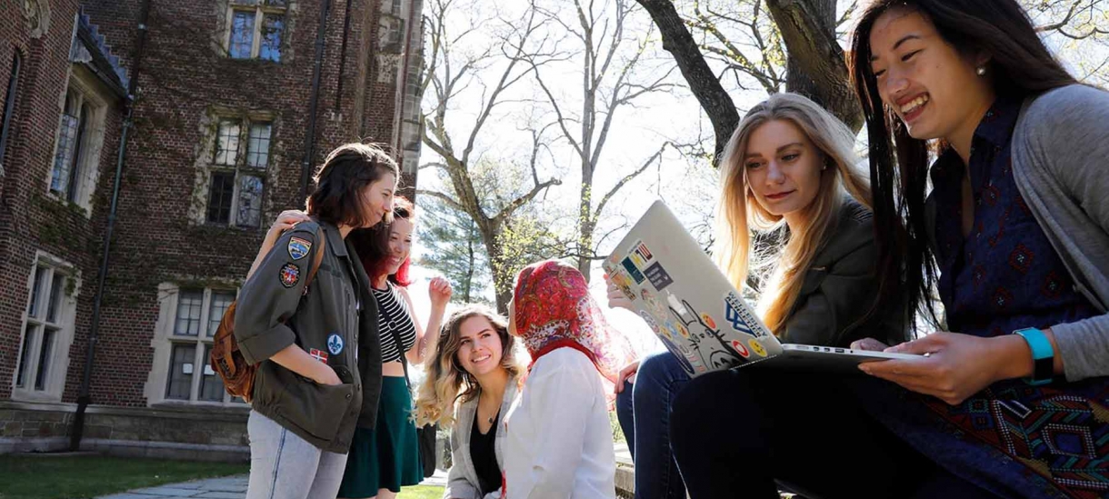 Small group of female students gathered outside.