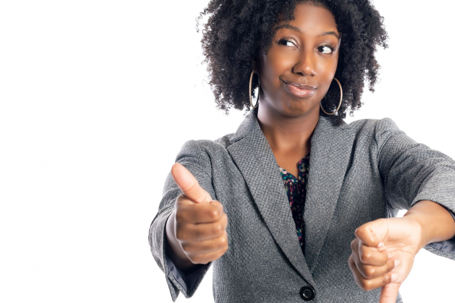 stock image of woman holding thumbs up and thumbs down