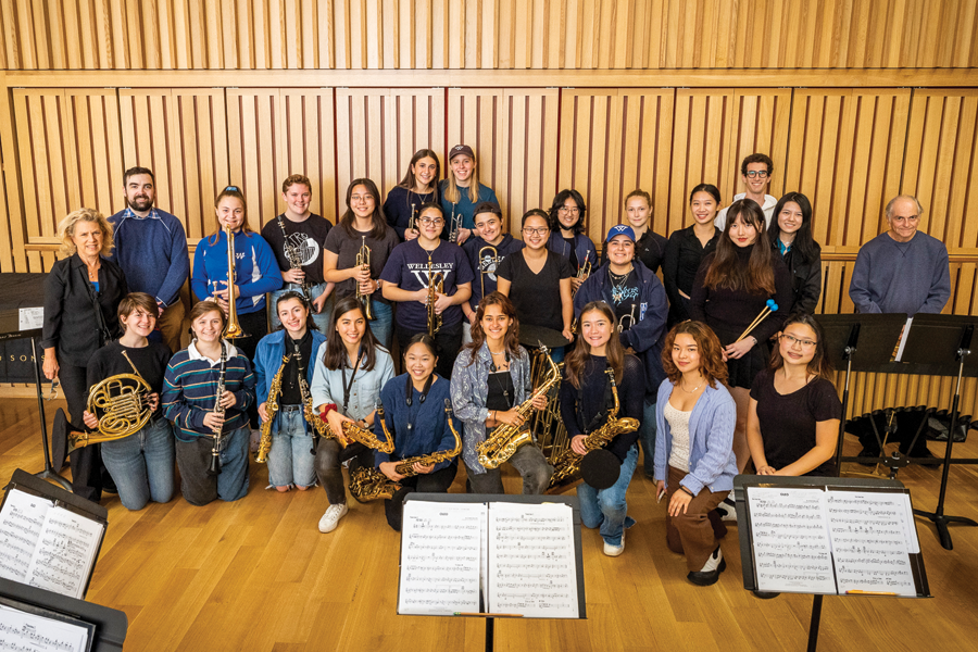 students smiling and holding instruments