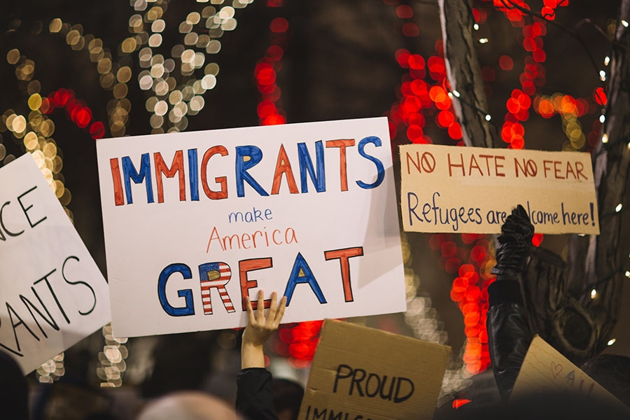 protest signs in support of immigrants and refugees