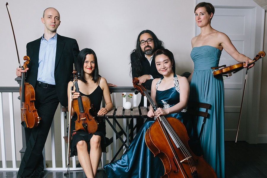 image of 5 adults in formal attire holding their instruments and looking at the camera