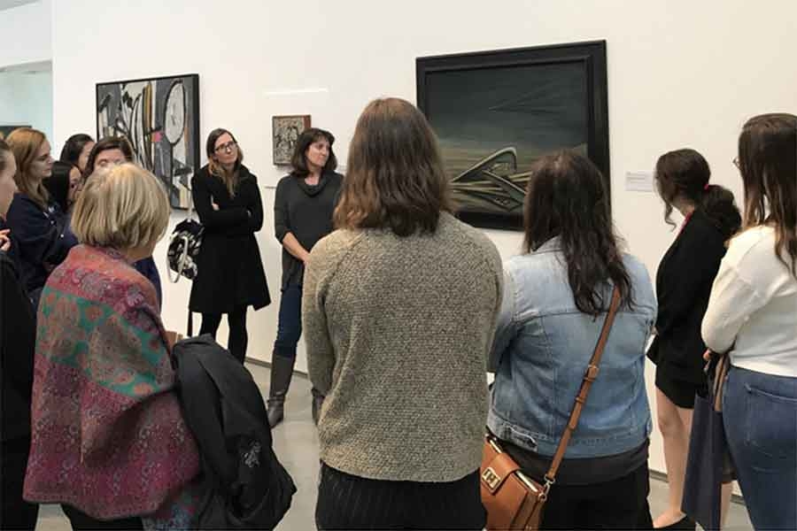 group of people looking at artwork in the davis museum