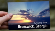 Dear Wellesley: Evan Williams ’17 Writes from the Georgia (U.S.) Coast Hand holds a postcard that reads "Greetings from Brunswick, Georgia"