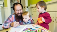 Faculty Members Find Inspiration In Family David Teng-Olsen, assistant professor of art, colors with his sons, Jack and Felix.