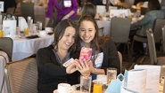 Student Chosen As Finalist In National Essay Contest Leilani Stacy ‘18, a finalist in a national essay contest, snaps a picture with her mother at a gathering hosted by the contest’s sponsoring organization, Womenetics.