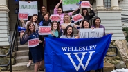 Congratulations, Admitted Students! The Admission Office team holds signs welcoming newly-admitted students.