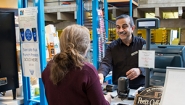 Ashraf Youssef serves a customer at the Leaky Beaker Cafe