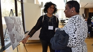 Alumnae view a photo at the Harambee House 45th Anniversary celebration