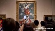 Racial Stereotypes and Racist “Love” Art patron holds up a cell phone during protest MFA protest in front of Claude Monet painting