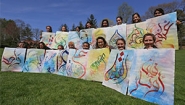 Spotlight on Teaching: MES/ART116: Arabic Calligraphy Students hold art from a calligraphy project exploring Arabic letters