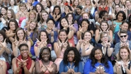 crowd of student leaders flash W hand signal