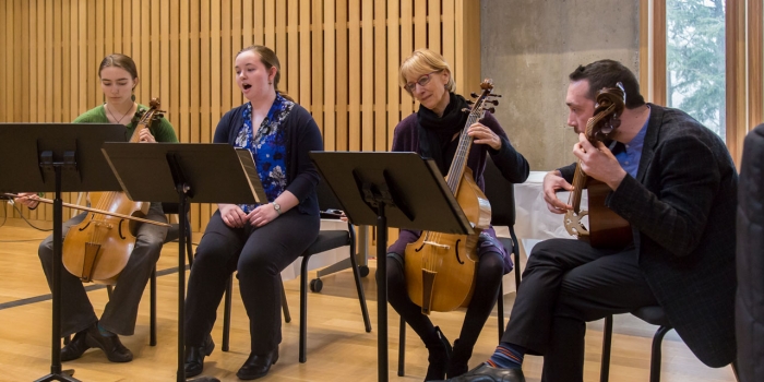 Symposium Celebrates Four Years of Wellesley’s Innovative Blended Learning Initiative Two students and two professors play musical instruments on a stage.