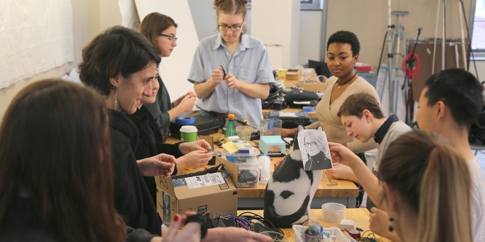 Boston Art Installation Inspired by Latin American “Sobremesa” Amplifies Community Voices A group of students and staff work on an art project