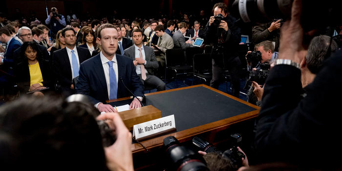 Rethinking Online Interactions: Healthy Digital Ecosystems Should Matter Like Clean Air and Water Mark Zuckerberg sitting at a table in Congress with media surrounding him