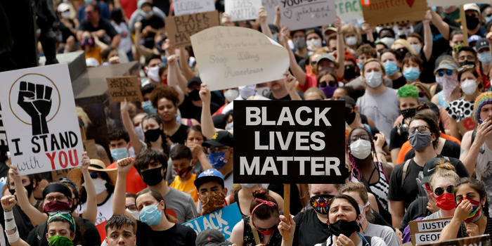 BLM One Year Later: What Shifts in Support Mean for the Movement and Race Relations in 2021 BLM protesters hold signs