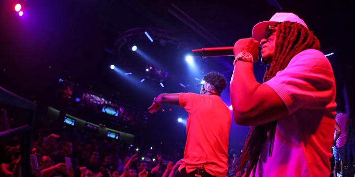 Wellesley Professor Explains Reggaeton’s Relationship to the African Diaspora in Puerto Rico and the Dominican Republic A male performer sings on stage.