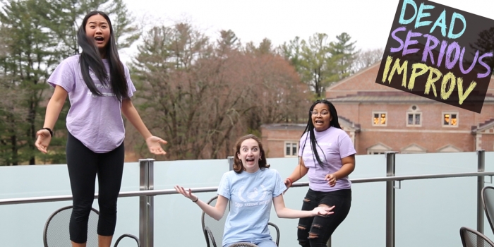 Wellesley Student Improv Group Is Dead Serious About New Schedule Upgrades Three students stand in a patio space at Wellesley, looking alarmed.