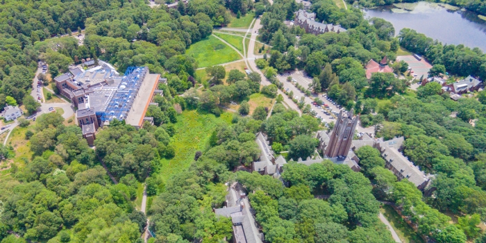 Wellesley Earns Gold Rating for Sustainability Efforts An aerial view of Wellesley's campus featuring lake waban and green hall.