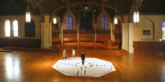 The Labyrinth Project Continues to Support Campus Wellness Three women walk a labyrinth inside Houghton Chapel.