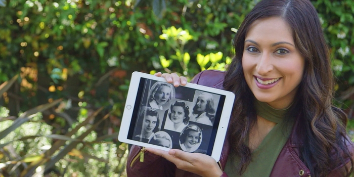 Wellesley Women Were Pioneers in Code Breaking and Code Making A woman holds an iPad with old photos of women.