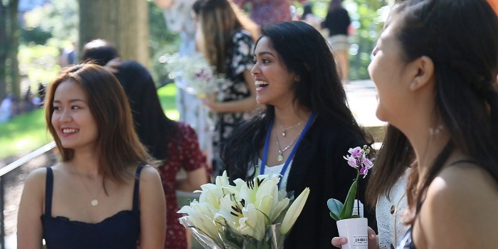 Wellesley Celebrates 144th Flower Sunday students smiling and holding flowers