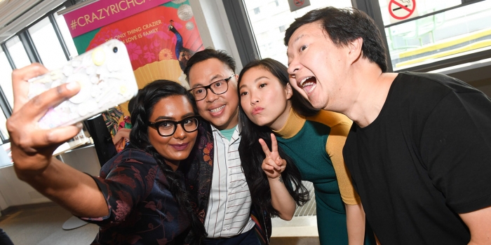 Appearing on WGBH, Wellesley Professor Discusses Impact of Movie “Crazy Rich Asians” The cast and crew of Crazy Rich Asians take a photo with a fan.