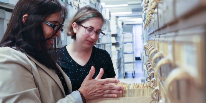 What I Did This Summer: Professor Lisa Rodensky, English Two women look at a card catalogue in the archives.