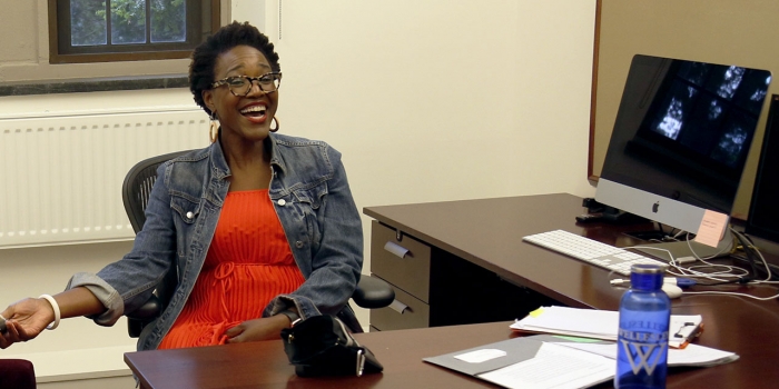 What I Did This Summer: Nikki A. Greene, Assistant Professor of Art Nikki Green sitting at a desk and smiling
