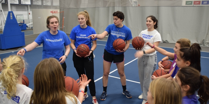 PERA Hosts Youth Sports Clinic to Celebrate National Girls and Women in Sports Day A group of student athletes lead a clinic with young girls.