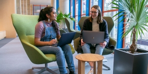 Meet the Student Founders of the Wellesley Data Collective Investigating the Campus Electorate Two students sit at a table in the science center.