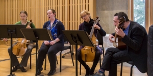Symposium Celebrates Four Years of Wellesley’s Innovative Blended Learning Initiative Two students and two professors play musical instruments on a stage.