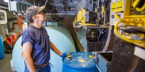 As One of Wellesley’s Master Plumbers, Leslie Pano ’77 Knows the College’s Inner Workings A woman looks up at piping attached to a well.