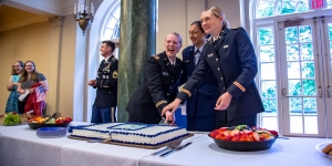 Wellesley’s Class of 2019 ROTC Cadets Begin Careers as Military Officers Three ROTC cadets cut a cake with a saber