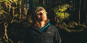 Environmental Activist and Filmmaker Elsa Sebastian ’13 Is Working to Protect Her Alaskan Home Elsa Sebastian standing in the forest with sun shine on her face