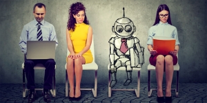 Is AI Sexist? Wellesley Computer Science Professor Looks Into a Recent Amazon Recruiting Experiment Three humans and a robot sit outside an interview room.