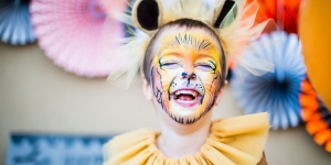 Why Do Kids Pretend to Be Animals? Wellesley Professor Explains A child dressed up as a lion. He laughs.