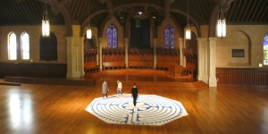 The Labyrinth Project Continues to Support Campus Wellness Three women walk a labyrinth inside Houghton Chapel.