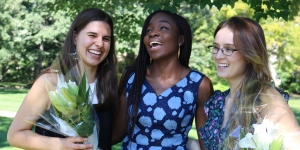 Wellesley Community Celebrates Flower Sunday Three students laugh together on Flower Sunday.