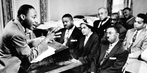 Students Celebrate the Life and Legacy of Martin Luther King through Service Martin Luther King talks to activists from a podium in a small room
